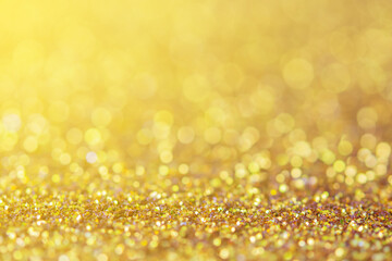 blurred sparkling gold glitter light as abstract festive background for website banner and card decoration