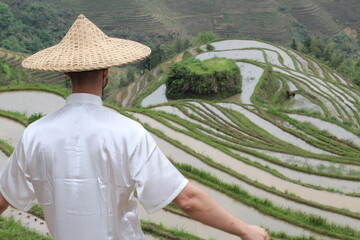 Man working in traditional Asian rice fields