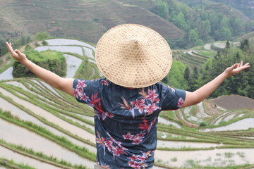 Fototapeta premium Man working in traditional Asian rice fields