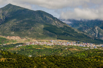 Panoramic view on the blue city of Chefchaouen in Morocco under the mountains