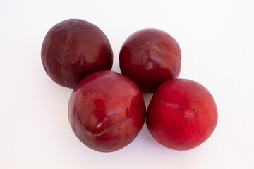Delicious red plums on white background