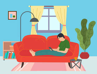 Guy lying on red sofa with smartphone, surfing Internet. Cozy home furnishings, windows, curtains, round coffee table, lush potted plant, bedside table with books, floor lamp. Living room items