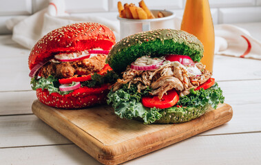 Homemade various chicken burger with colorful buns, kale, red onion, tomato and mayonnaise sauce