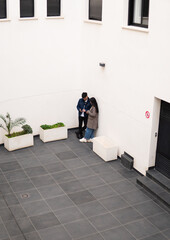 Fototapeta premium Couple standing against a wall alone.