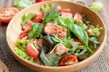 Grilled salmon and vegetables. Green and healthy food. Fish salad in wooden dish. 