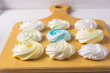 Homemade sweet colored meringue on wooden background.  .Dessert.