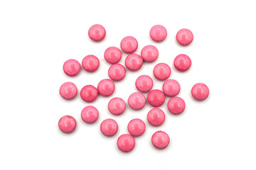 Closeup of pink small candies on white background