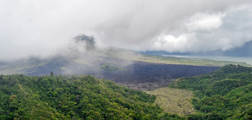 Gunung Batur is active volcano in the tropical island of Bali. The height of the volcano is 1717 meters