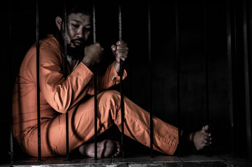 Asian man desperate at the iron prison,prisoner concept,thailand people,Hope to be free,Serious...