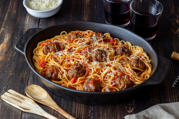 Meatballs with spaghetti, tomato sauce and parmesan cheese. Italian cuisine.