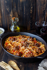 Meatballs with spaghetti, tomato sauce and parmesan cheese. Italian cuisine.