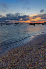 Sunrise on the sea coast with rocks