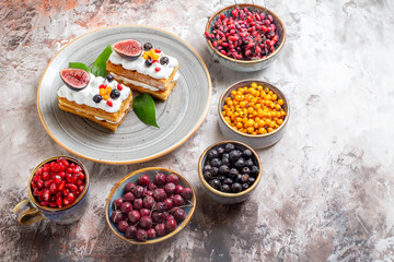 top view delicious cream cakes with different fruits on a light background dessert pie sweet color photo