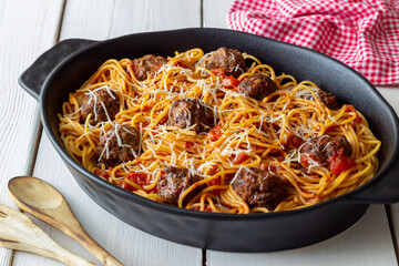 Meatballs with spaghetti, tomato sauce and parmesan cheese. Italian cuisine.