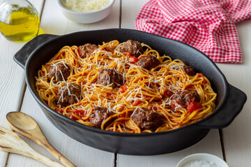 Meatballs with spaghetti, tomato sauce and parmesan cheese. Italian cuisine.