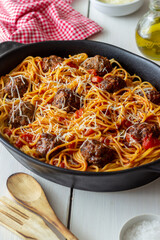 Meatballs with spaghetti, tomato sauce and parmesan cheese. Italian cuisine.