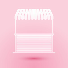 Paper cut Street stall with awning and wooden rack icon isolated on pink background. Kiosk with wooden rack. Paper art style. Vector.