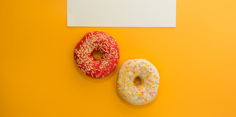 Fototapeta na wymiar Donuts isolated on yellow background. Delicious glazed donuts close-up. Donut