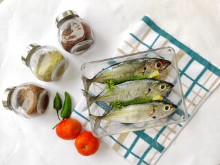 Close up view of Fresh Indian Scad Fish decorated with herbs and vegetables.Selective focus.