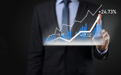 Businessman on a black background presses, presses a finger on a positive growth arrow. Graphs of indicators. Business development and finance concept