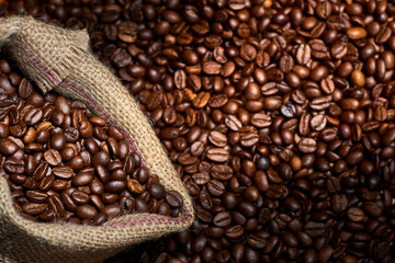 Studio Shot  of Coffee and Burlap Bag with Coffee over coffee beans