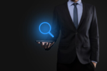 Businessman, man hold in hand magnifying glass icon.business, technology and internet concept