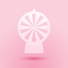 Paper cut Lucky wheel icon isolated on pink background. Paper art style. Vector.