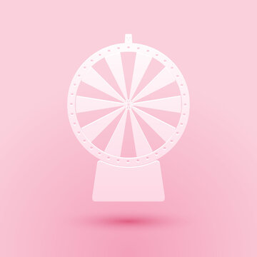 Paper cut Lucky wheel icon isolated on pink background. Paper art style. Vector.