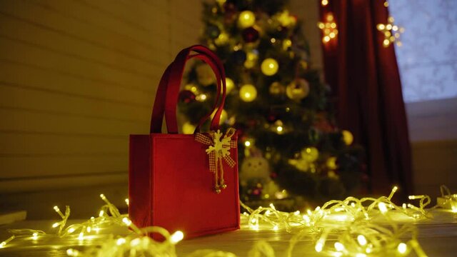 Christmas present on table against the background of the Christmas tree
