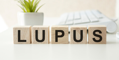 Wooden block form the word LUPUS. Medical concept.