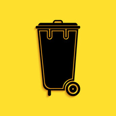 Black Trash can icon isolated on yellow background. Garbage bin sign. Recycle basket icon. Office trash icon. Long shadow style. Vector.