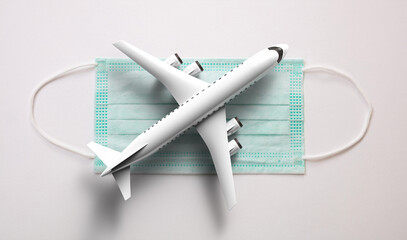 Plane model and medical mask on white background. 3d illustration