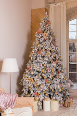 Modern living room space, comfortable sofa and christmas tree and presents under it in large suite. Contemporary designer mansion.luxurious expensive light interior living room.