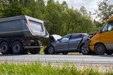 damaged cars on the highway at the scene of an accident