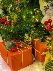 Preparing for Christmas and New year . The caramel cane is a traditional white-and-red-striped candy on Christmas holidays. Christmas tree decorations with red berries and white lamp