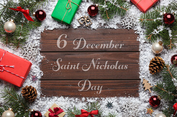 6 December Saint Nicholas Day. Christmas decorations on wooden background, flat lay