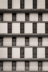 Obraz premium Rows of glazed windows and glass railings of a minimalist urban building