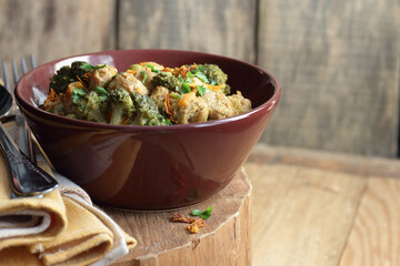 Soy goulash, protein food with stewed vegetables: pea, broccoli, carrot and spices, healthy vegan meal - a source of proteins, closeup, copy space
