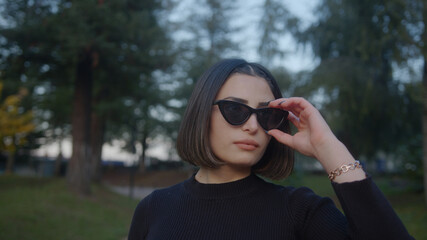 Beautiful young woman with the street and having modern sunglasses. Fashion Concept