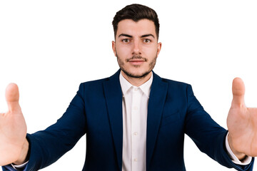 Young brown-haired businessman on a white background with outstretched hands towards the camera