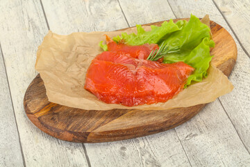 Sliced salmon fillet served rosemary