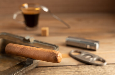 Relaxing and smoking a cigar with a nice drink on the side.