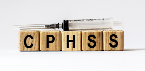Text CPHSS made from wooden cubes. White background