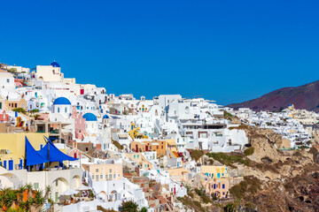 Fototapeta premium Oia village, the most picturesque village on Santorini island, a famous touristic resort in the Cyclades islands, Aegean sea, Greece, Europe