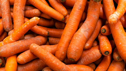 a lot of carrots on the counter background red