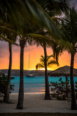 Obraz na płótnie Canvas sunset on the beach with sailboat
