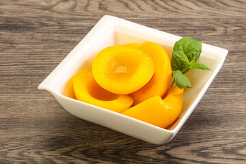 Sweet ripe canned peaches with mint