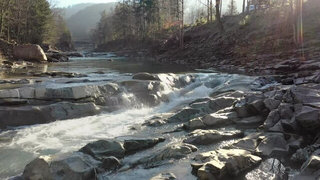 Wild mountain river flowing with stone boulders and stone rapids. Probiy river in the Carpathians, Ukraine