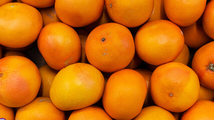 Ripe blood oranges for sale on a market top view