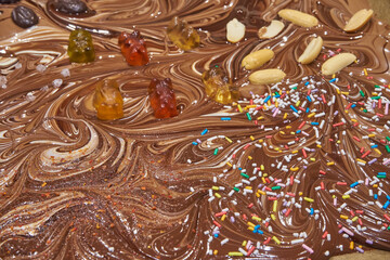 Handmade chocolate with several toppings, broken chocolate